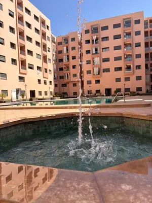 a fountain in a courtyard in front of buildings at NEW Marrakech Pool Center - ONLY FAMILY in Marrakech