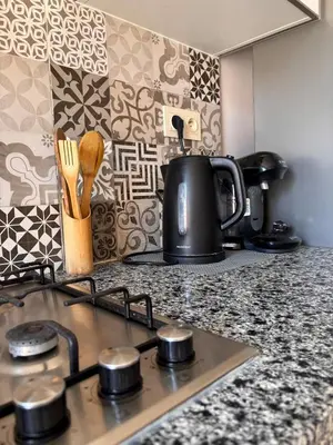 a kitchen counter with a tea kettle on a stove at NEW Marrakech Pool Center - ONLY FAMILY in Marrakech