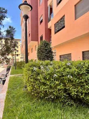 a bush in front of a building with a street light at NEW Marrakech Pool Center - ONLY FAMILY in Marrakech