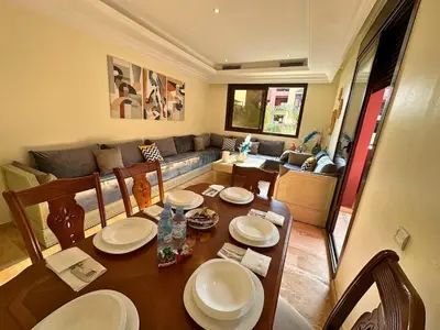a living room with a table and a couch at Modern Apartment in Centre of Marrakech For Friends & Familie in Marrakech