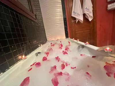 a bath tub filled with pink flower petals at Modern Apartment in Centre of Marrakech For Friends & Familie in Marrakech