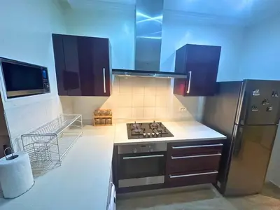 a kitchen with a stove and a refrigerator at Modern Apartment in Centre of Marrakech For Friends & Familie in Marrakech