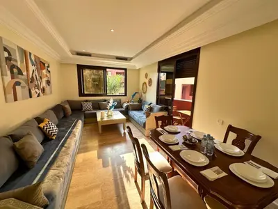 a living room with a table and a couch at Modern Apartment in Centre of Marrakech For Friends & Familie in Marrakech