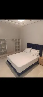 a bedroom with a large bed with white sheets at Chambre Marrakech 1 in Marrakech