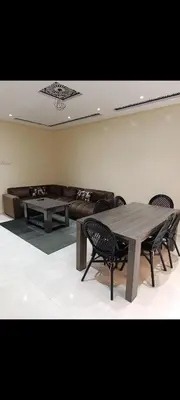 a living room with a couch and a table and chairs at Chambre Marrakech 1 in Marrakech