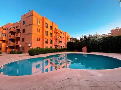 an empty swimming pool in front of a building at Homes 365 Residence Caricia in Marrakech