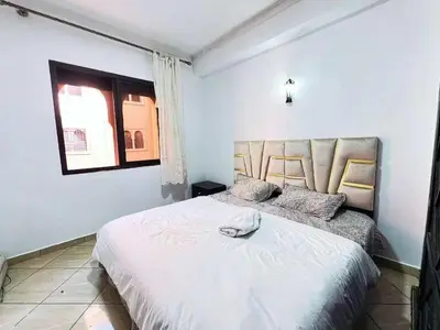 a bedroom with a large white bed with a window at Homes 365 Residence Caricia in Marrakech
