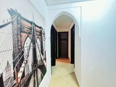 a hallway with a painting of a ship on the wall at Homes 365 Residence Caricia in Marrakech