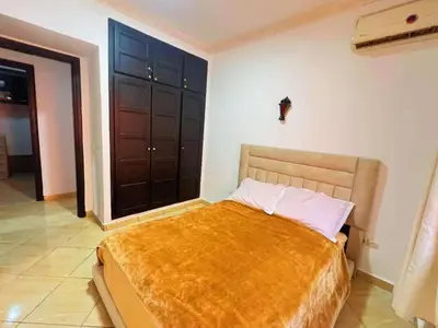 a bedroom with a bed with a gold blanket on it at Homes 365 Residence Caricia in Marrakech