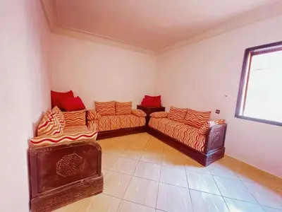 a living room with two beds and a window at Homes 365 Residence Caricia in Marrakech