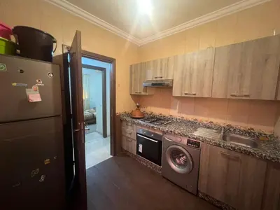 a kitchen with a washing machine and a refrigerator at Homes 365 Residence Caricia in Marrakech
