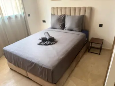 a bed with a pair of shoes sitting on it at Beautiful 5 bedroom duplex! Pool! in Oulad Akkou