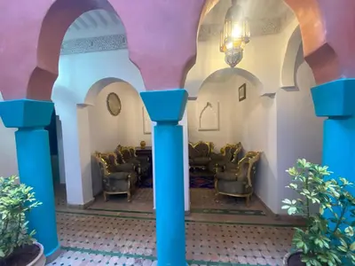 a waiting room with chairs and a chandelier at Riad Massin Marrakech in Marrakech