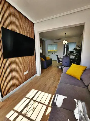 a living room with a flat screen tv on a wall at Appartement de luxe à Marrakech in Marrakech