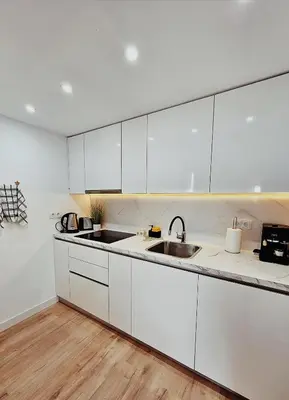 a kitchen with white cabinets and a sink at Appartement de luxe à Marrakech in Marrakech