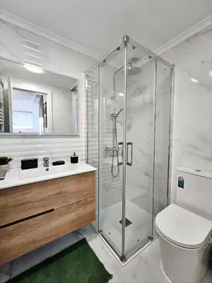 a bathroom with a shower and a toilet and a sink at Appartement de luxe à Marrakech in Marrakech