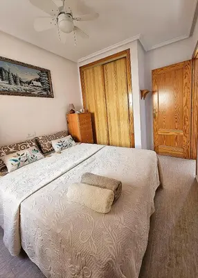 a bedroom with a large white bed with a pillow on it at Appartement de luxe à Marrakech in Marrakech