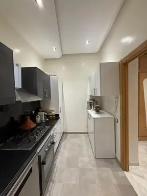 a kitchen with a stove and a refrigerator at Riad Garden Apartement & WiFi & Pool & Parking in Marrakech