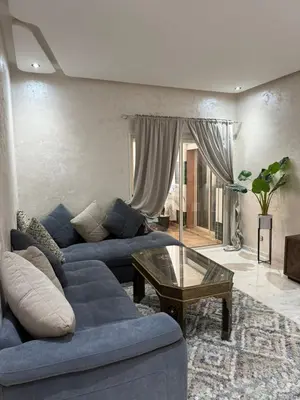 a living room with a blue couch and a coffee table at Riad Garden Apartement & WiFi & Pool & Parking in Marrakech