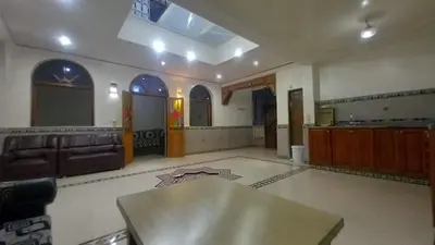 a large living room with a table and a couch at Appartement 2 Chambres à Belbekkar, Marrakech in Marrakech