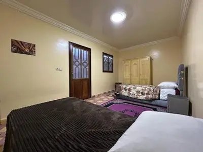 a bedroom with a bed and a couch in it at Maison d'hôtes Marrakech in Marrakech