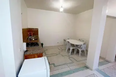 a kitchen with a table and a table and chairs at Appartement 3 chambres - Marrakech Belbekkar in Marrakech
