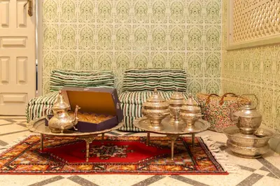 a living room with a couch and a box on a table at Riad Hbibti Authentic Moroccan Stay with Rooftop Jacuzzi in Marrakech