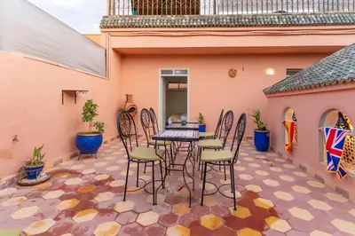 a patio with a table and chairs on a courtyard at Riad Hbibti Authentic Moroccan Stay with Rooftop Jacuzzi in Marrakech