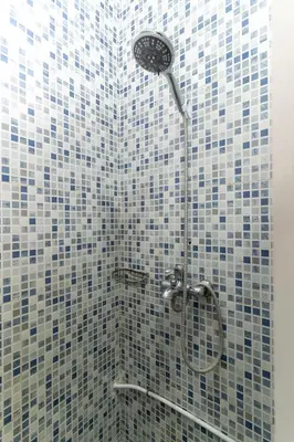 a bathroom with a shower with blue and white tiles at Riad Hbibti Authentic Moroccan Stay with Rooftop Jacuzzi in Marrakech