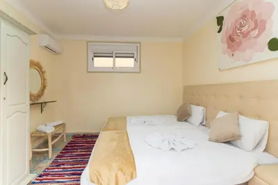 a bedroom with a bed with white sheets and a window at Riad Hbibti Authentic Moroccan Stay with Rooftop Jacuzzi in Marrakech