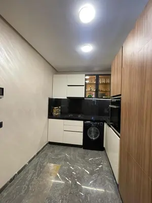 a small kitchen with a washing machine in it at Apartment for rent in Marrakech