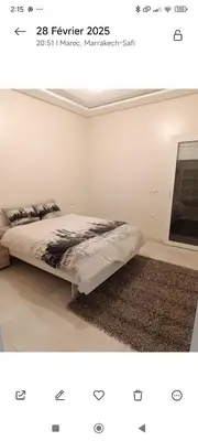 a white bedroom with a bed and a window at Chambre Marrakech 2 in Marrakech