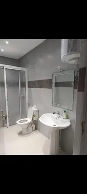 a bathroom with a sink and a toilet and a mirror at Chambre Marrakech 2 in Marrakech