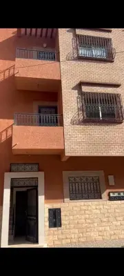 a large brick building with barred windows and a door at Chambre Marrakech 2 in Marrakech