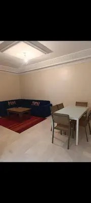 a room with a table and chairs and a couch at Chambre Marrakech 2 in Marrakech