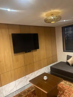 a living room with a couch and a flat screen tv at Apartment for rent in Marrakech