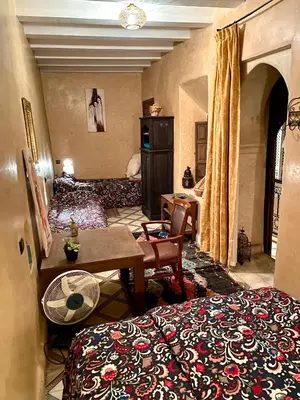 a room with a bed and a table in a room at Riad Sylvia in Marrakech