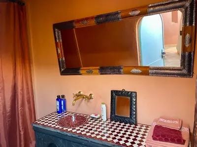 a bathroom with a sink and a mirror on a counter at Riad Sylvia in Marrakech