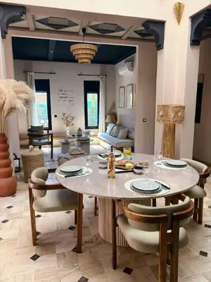 a dining room with a large table and chairs at Riad Perles d'Annellia in Marrakech