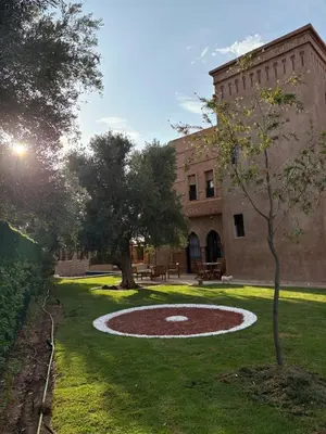 a building with a large circle in the grass at Riad Perles d'Annellia in Marrakech