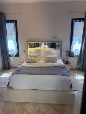a large bed sitting in a bedroom with windows at Riad Perles d'Annellia in Marrakech