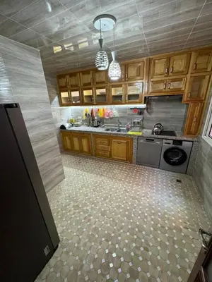 a large kitchen with wooden cabinets and a stove at شقة بغرفة معيشة مغربية in Marrakech