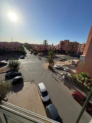 a street with cars parked in a parking lot at شقة بغرفة معيشة مغربية in Marrakech