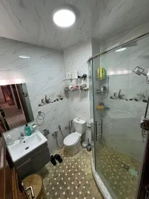 a bathroom with a shower and a toilet and a sink at شقة بغرفة معيشة مغربية in Marrakech