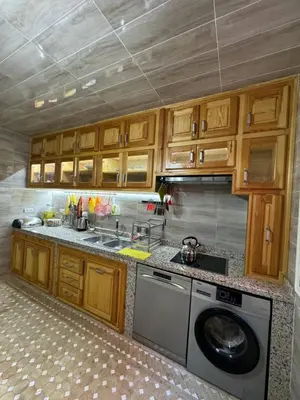 a kitchen with a washing machine and a sink at شقة بغرفة معيشة مغربية in Marrakech