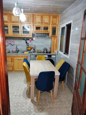 a kitchen with a table and chairs in a kitchen at شقة بغرفة معيشة مغربية in Marrakech