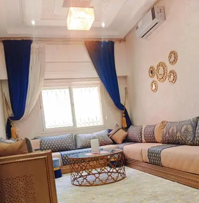a living room with a couch and a table at Appartement Marrakech à 10 minutes de l'aéroport in Marrakech