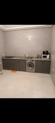 a kitchen with a washing machine and a microwave at Chambre Marrakech 3 in Marrakech