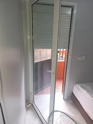 a sliding glass door with a view of a room at Chambre Marrakech 3 in Marrakech