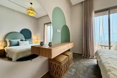 a hotel room with two beds and a mirror at Modern 2-Bedroom Apartment in Agdal with Pool & Terrace in Marrakech
